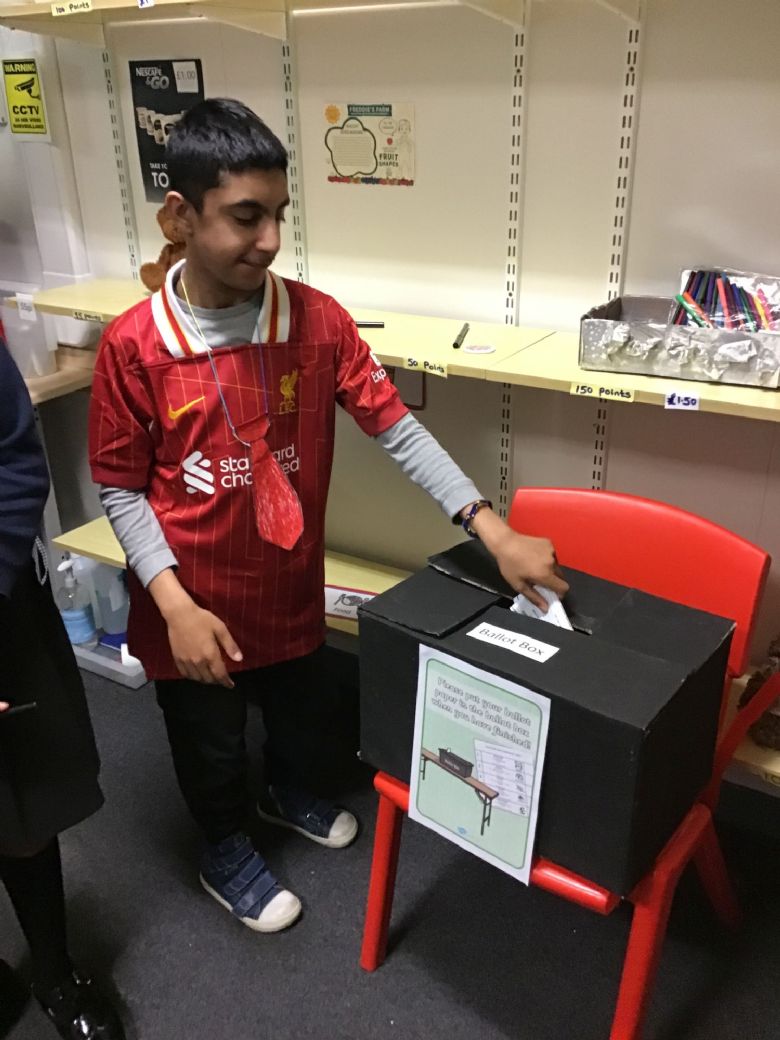 Musa, campaigner for the Labour party placing his vote in the ballot box. 